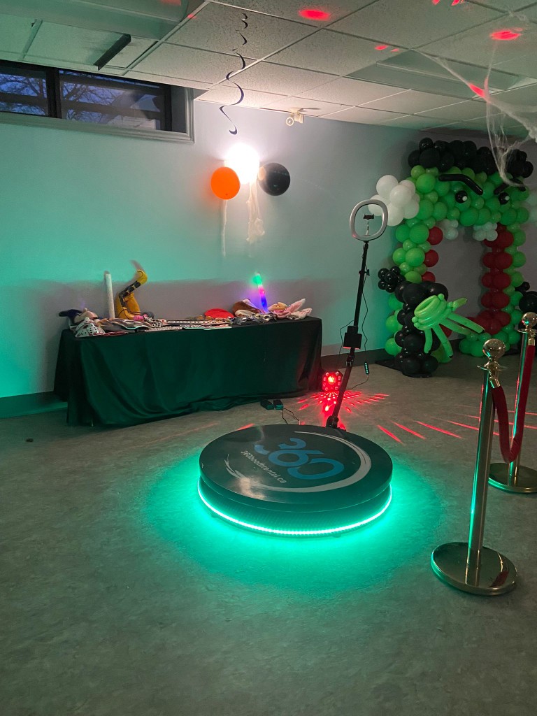 360 video booth with props and balloon decor