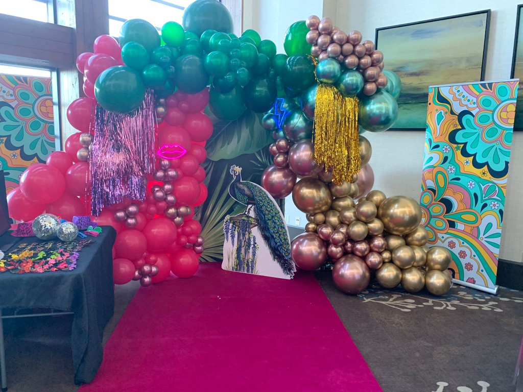 balloon decor, a red carpet, and props