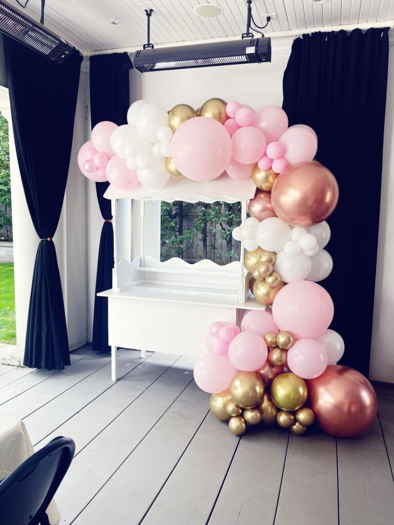 balloon decor and a candy cart