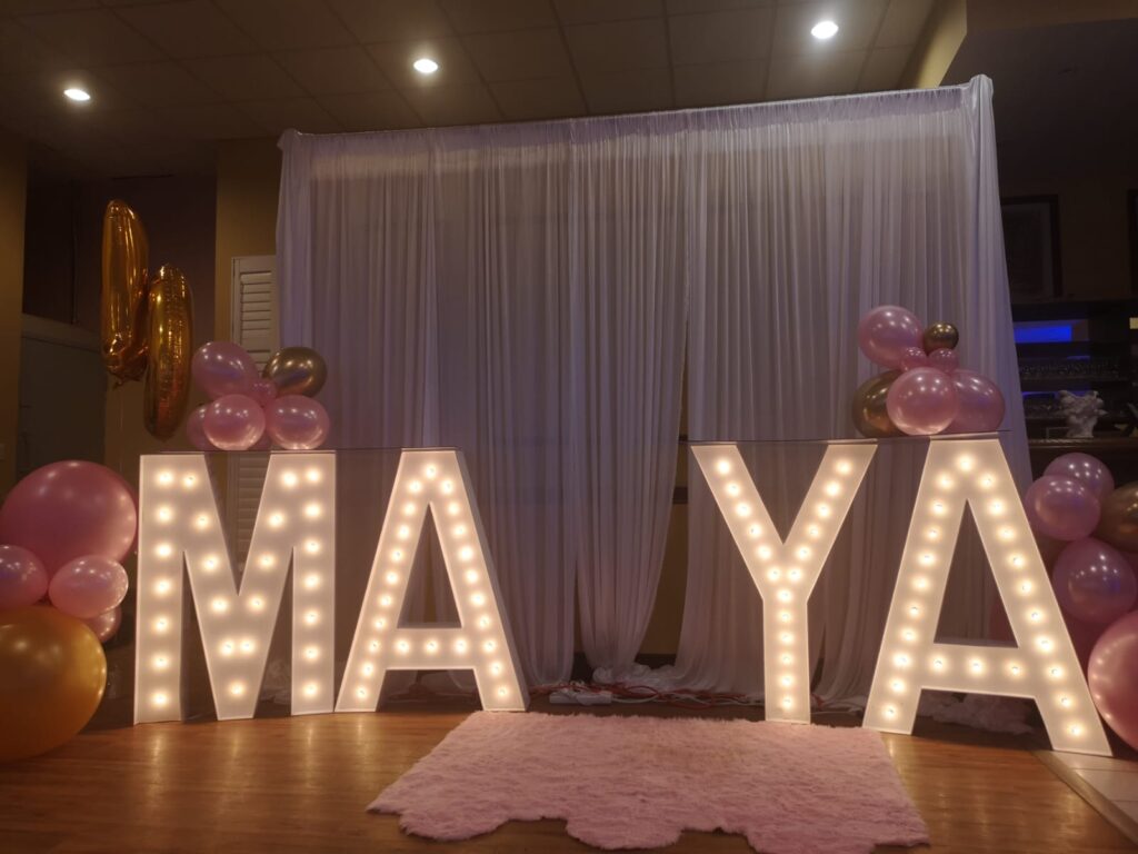 white drapes, marquee letters and balloon decor