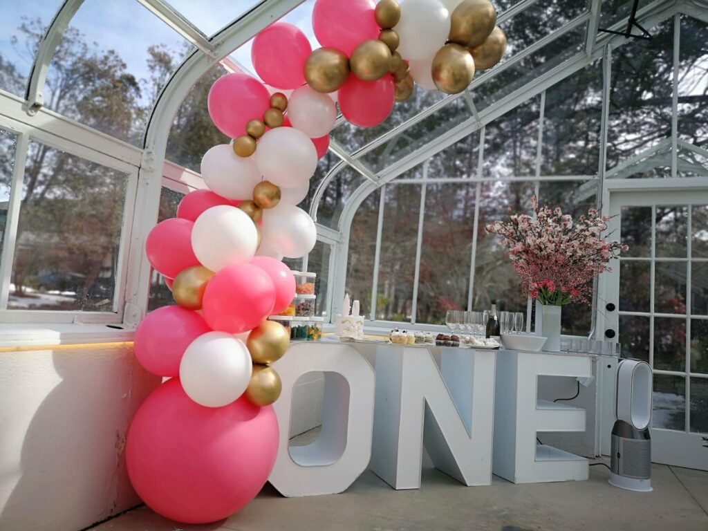 half balloon arch with a marquee letter table.