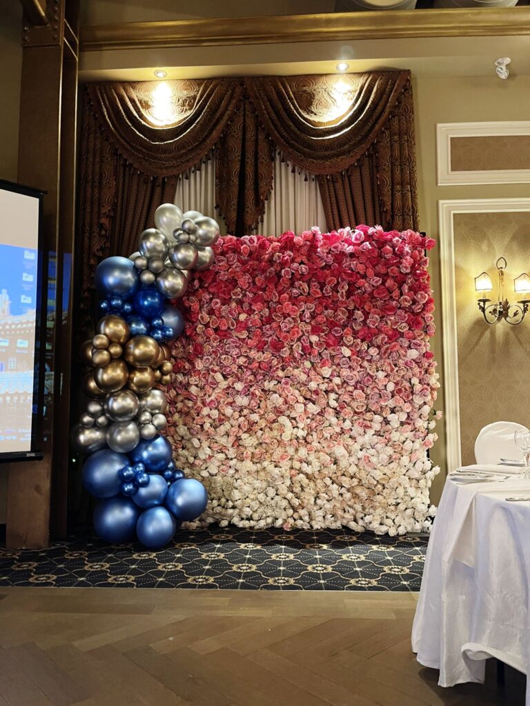 Balloon garland with a mixed flower wall